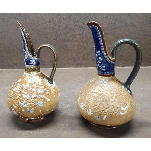 1038 - A matched pair of 19th Century Royal Doulton salt glaze miniature Ewers. H 14 cm approx.