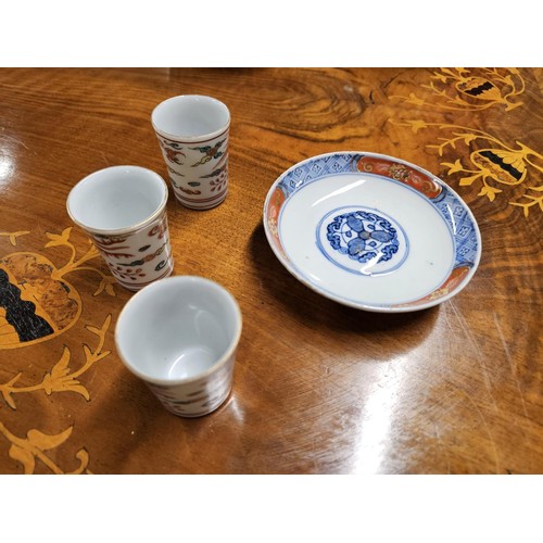 1046 - A good Oriental hand painted pin Dish along with three Saki Cups.