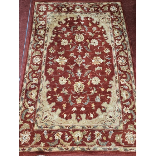 1094 - A rust coloured Rug with multi borders and unique medallion design. L 244 x W 165 cm approx.