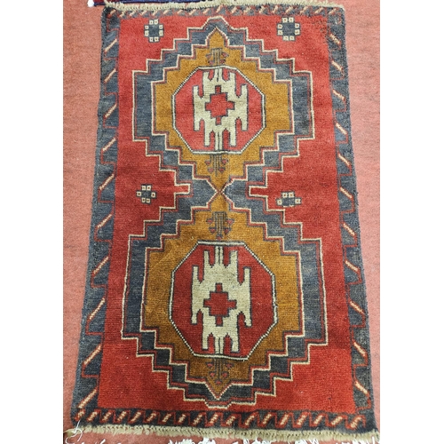 1097 - A Red and Blue ground Rug with medallion central design. H 140 x W 86 cm approx.