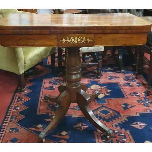 1119 - Of good quality. A Regency Mahogany Foldover Card Table with brass inlay top and frieze on quatrefoi... 