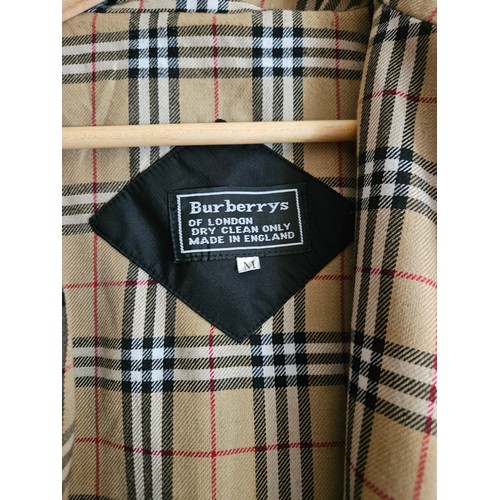 937 - A Black Burberry Coat, size Medium. 
Please note no condition reports will be done on this lot. We r... 