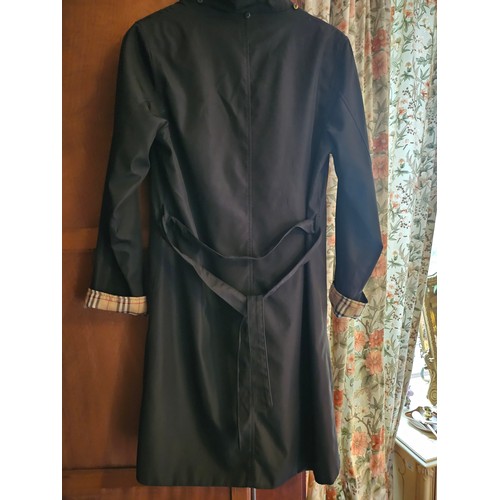 937 - A Black Burberry Coat, size Medium. 
Please note no condition reports will be done on this lot. We r... 