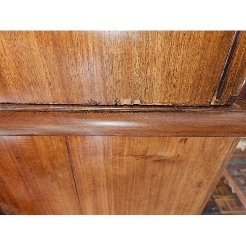 325 - An early 19th Century Mahogany two door Linen Press the base chest having two short over two long dr... 