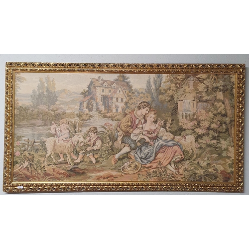 64 - A 20th Century Tapestry of a family with goats in a good gilt frame. 58 x 108 cm approx.