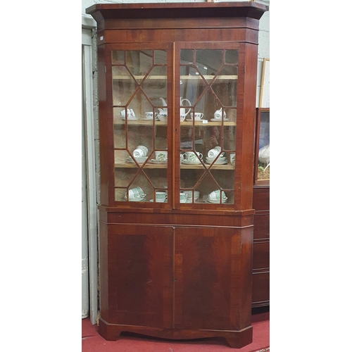 70 - A good 19th Century Mahogany Corner Cabinet of large size with glazed upper and panelled lower secti... 