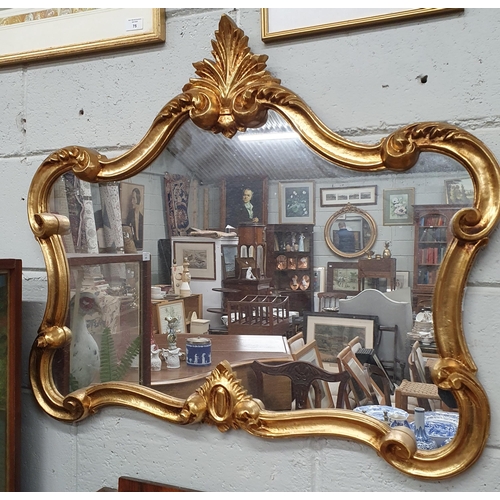 78 - A reproduction Plaster Gilt Mirror with highly moulded outline and cartouche top. 82 x 69 cm approx.