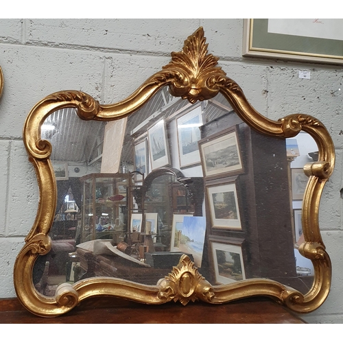 79 - A reproduction Plaster Gilt Mirror with highly moulded outline and cartouche top. 82 x 69 cm approx.