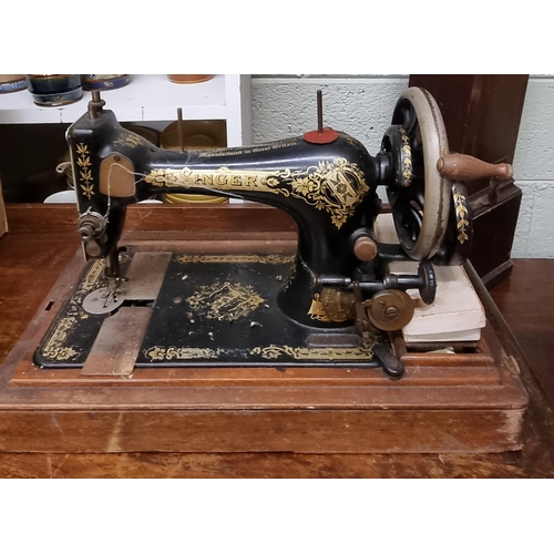 128 - A cased Singer Sewing Machine.