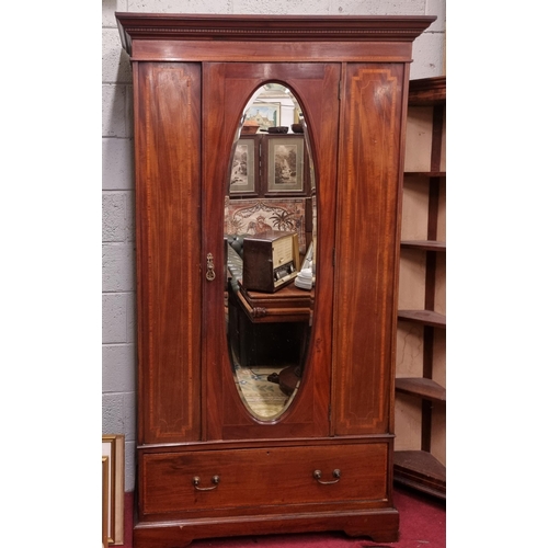 139 - An Edwardian Mahogany and Inlaid single door Wardrobe with oval mirrored centre. 112 x 47 x H 201 cm... 