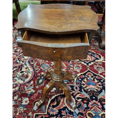 234 - A 19th Century Mahogany Side Table with serpentine outline and single frieze drawer on quatrefoil po... 