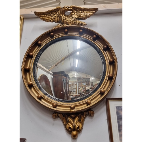 572 - A late 19th early 20th Century Timber and Plaster Gilt convex Mirror with eagle surmount. 46 x 72 cm... 