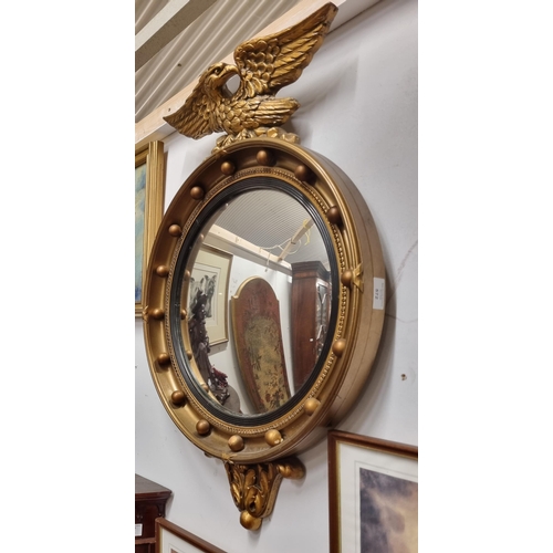 572 - A late 19th early 20th Century Timber and Plaster Gilt convex Mirror with eagle surmount. 46 x 72 cm... 