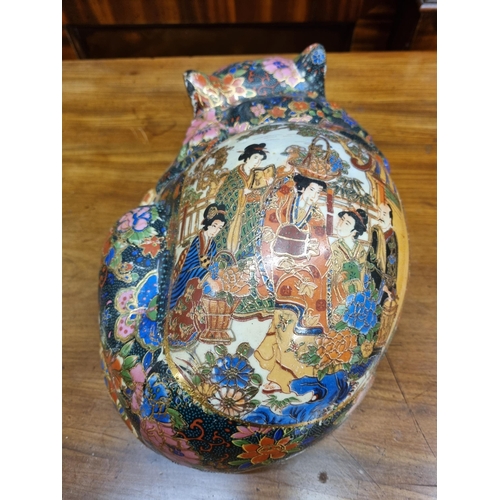 583 - A 20th Century Oriental Porcelain Figure of a cat.
L 30 cm approx.