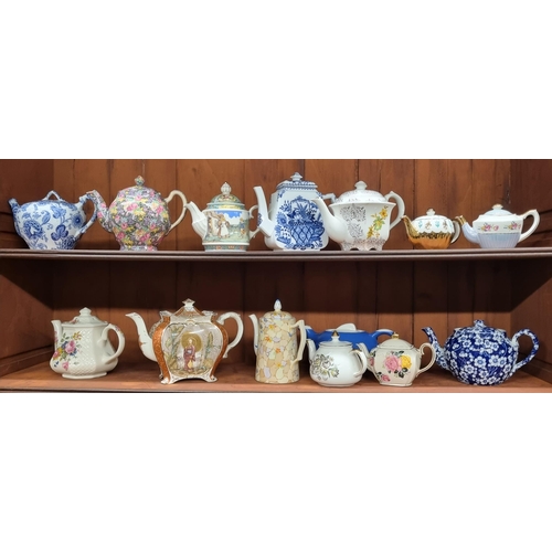 588 - A good quantity of 19th Century and later teapots on two shelves.