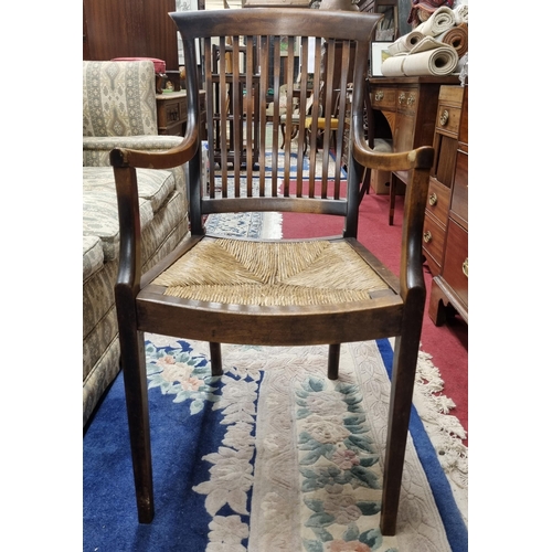 620 - A late 19th early 20th Century flatback Armchair with rush seat on square tapered supports. W 52 x S... 