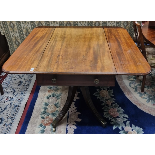 629 - An early 19th Century Mahogany Dropleaf Side Table on quatrefoil supports and brass castors.
 92 x 1... 