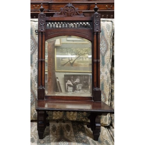 633 - A late 19th early 20th Century Mahogany wall mounted Bracket with mirrored back and pierced outline.... 