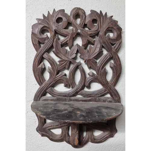 650 - A 19th Century highly carved Wall Bracket along with an unusual pipe.