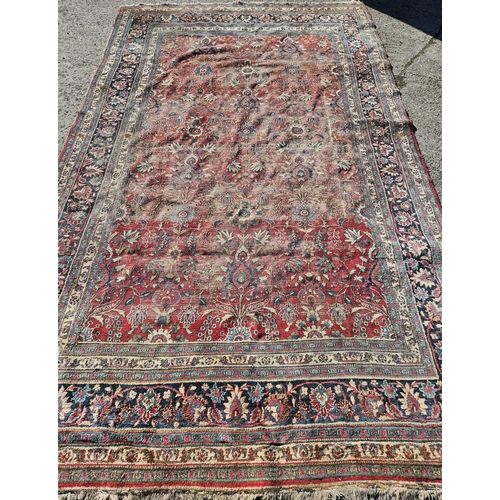 1277 - A large well worn Persian Burgundy ground Carpet with unique medallion design, 410 x 260 cm approx.