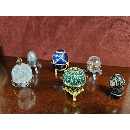 327 - A quantity of Faberge style Eggs. Tallest H 6.5 cm approx.