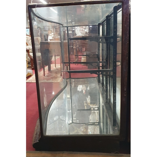 1072 - A 19th Century low shop Display with serpentine outline, with glass shelves. (glass cracked on top).... 