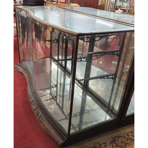 1072 - A 19th Century low shop Display with serpentine outline, with glass shelves. (glass cracked on top).... 