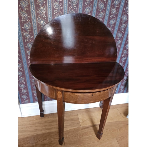 257 - A Regency Mahogany and inlaid half moon fold over Tea Table with square tapered supports and shell i... 