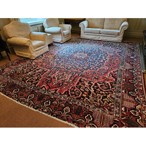 260 - A large red ground Persian Carpet with repeating central medallion design and multi borders. 350 x 4... 