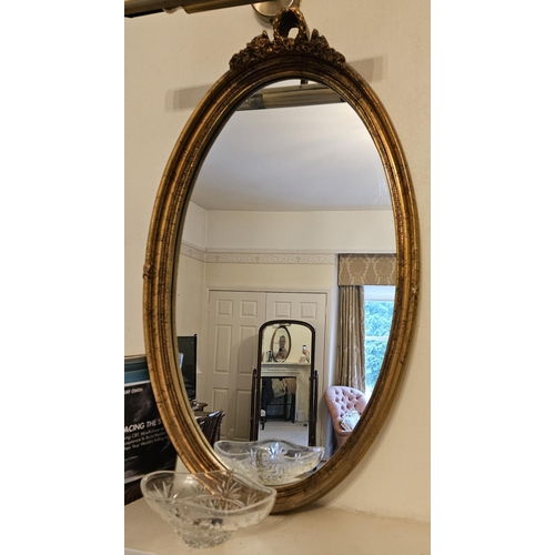 750 - A good modern Timber and Plaster Gilt oval Mirror. 46 x 78 cm approx.