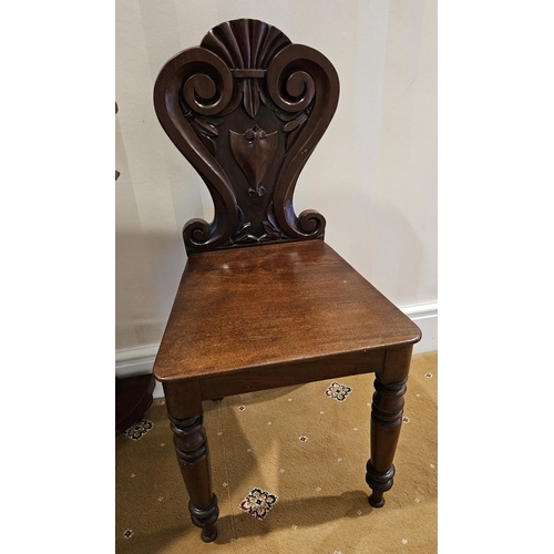 803 - A good pair of William 1Vth Mahogany Hall Chairs with highly carved backs and turned front supports.