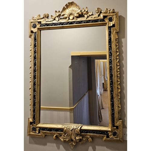 837 - A reproduction Timber and Plaster gilt Mirror with highly carved outline and shell cartouche top. W ... 