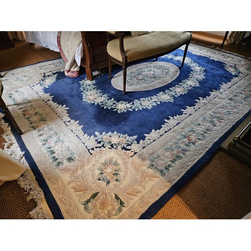 631 - A large Oriental blue ground Carpet with large central medallion design. 275 x 375 cm approx.