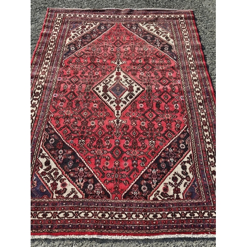 1085 - A rich Red ground hand woven Persian Sarouk Carpet with a traditional design, 350 x 270cm approx.