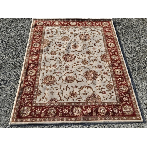 743 - A cream and burgundy ground Carpet with multi borders and unique medallion design. 170 x 226 cm appr... 