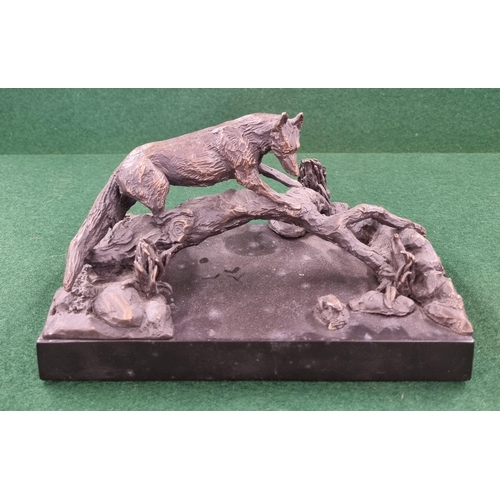 662 - A 20th Century Bronze Figure of a fox standing on a branch, signed E Mc D to the side.