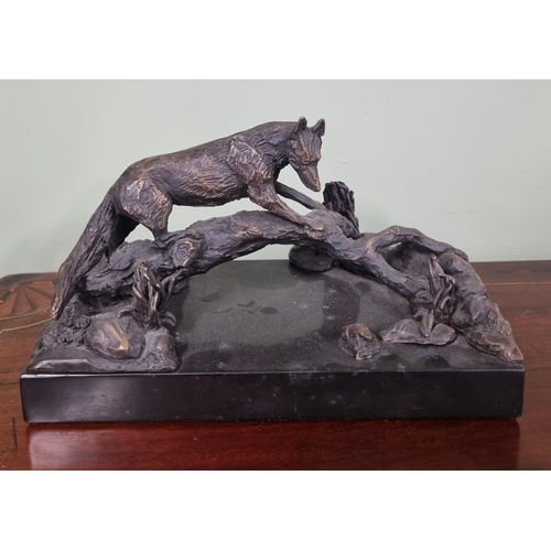 662 - A 20th Century Bronze Figure of a fox standing on a branch, signed E Mc D to the side.