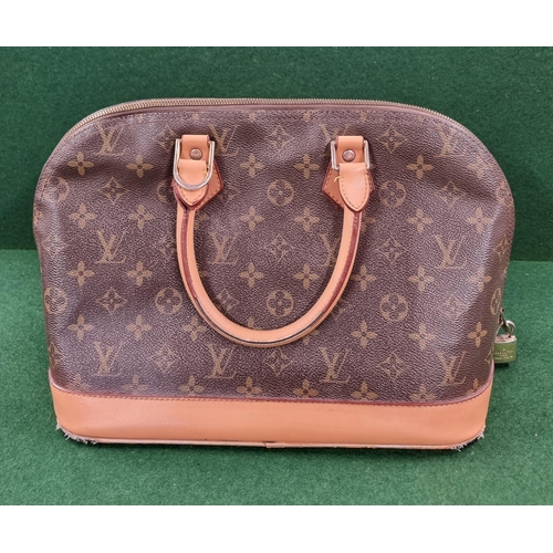 667 - An original Louis Vuitton Handbag, well used.