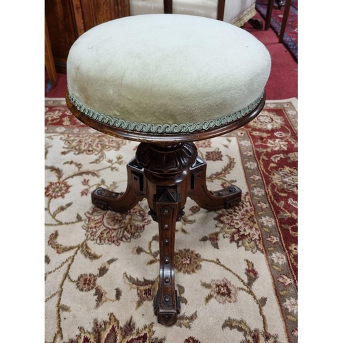 744 - A 19th Century Mahogany Piano Stool with highly carved tripod supports. D 34 cm approx.