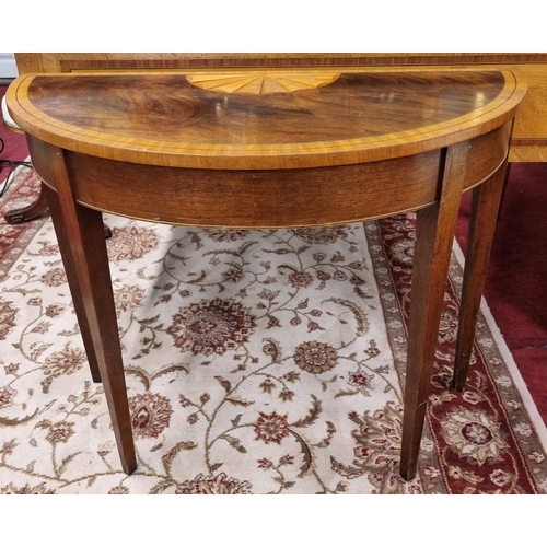 745 - A late 19th early 20th Century Mahogany half moon Table of narrow proportions with shell sunburst to... 