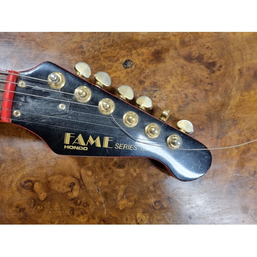 1004 - A Hondo flame series 764 electric Guitar in case.