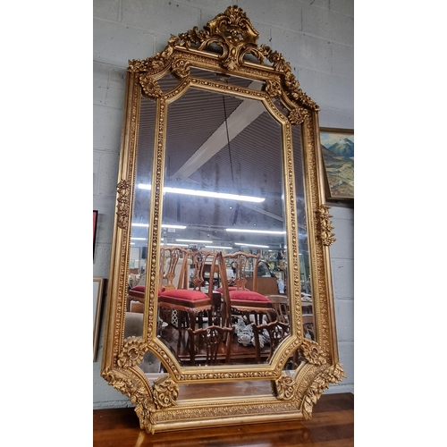 901 - An extremely large Timber and Plaster Gilt Overmantel Mirror with highly pierced cartouche top and s... 