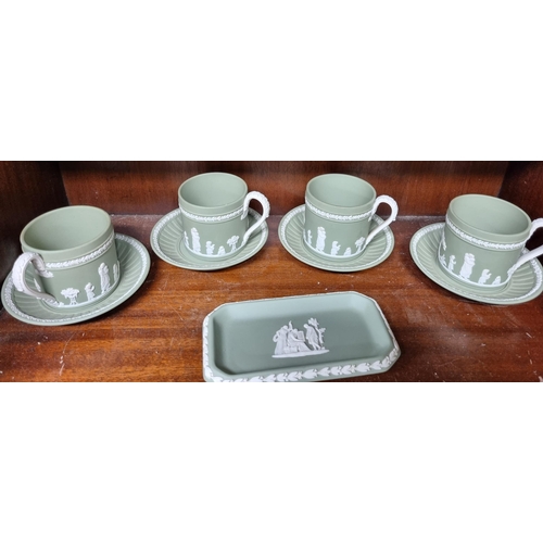 931 - A large quantity of Wedgwood green Jasperware on three shelves along with other items.