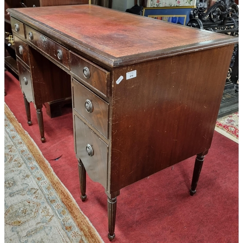 976 - An early 20th Century Mahogany Kneehole Desk with burgundy tooled leather top on turned reeded suppo... 