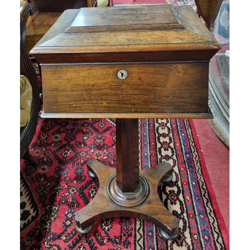 977 - A Regency Rosewood Teapoy of sarcophagus form with fitted interior on platform base. (lacking glass ... 