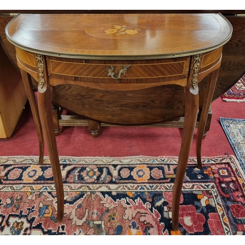 995 - A 20th Century Mahogany and crossbanded single drawer 
demi lune Side Table with ormolu mounts and c... 