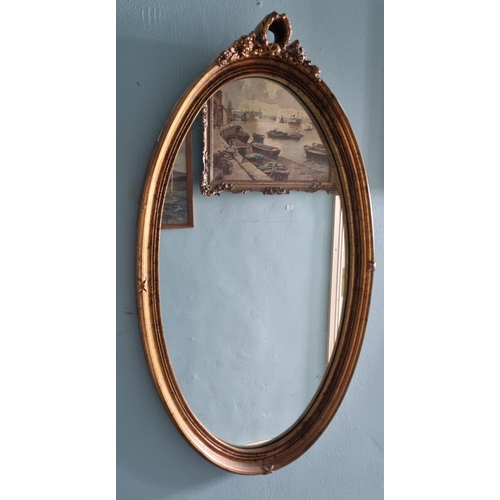 750 - A good modern Timber and Plaster Gilt oval Mirror. 46 x 78 cm approx.