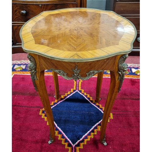 783 - A Continental Rosewood and Veneered Side Table with serpentine outline and ormolu mounts on cabriole... 