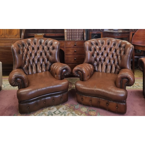 1032 - A good pair of leather effect deep buttoned wing back Armchairs. W 90 cm approx.