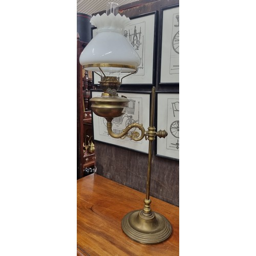 563 - A 19th Century Brass rise and fall Lamp with cloudy glass shade.